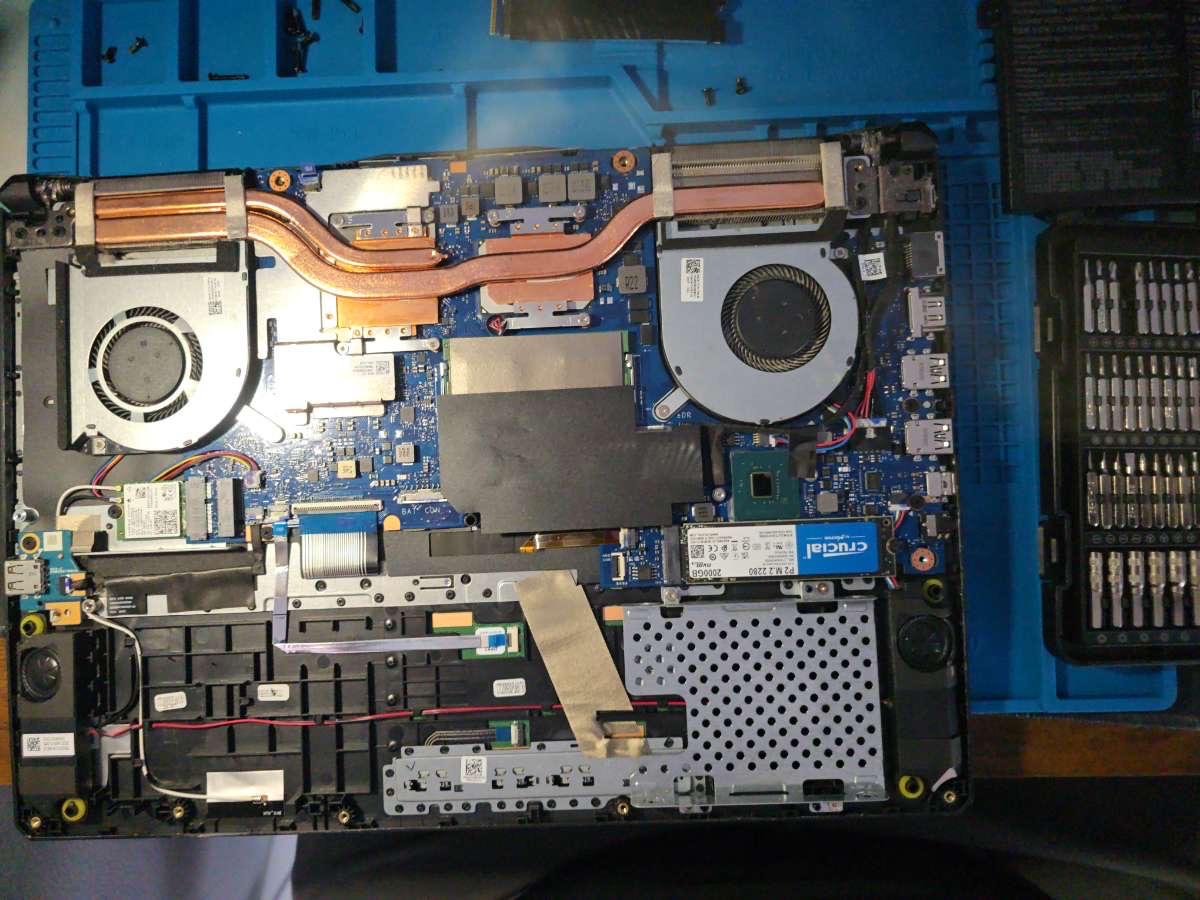 Laptop internals with cooling system and motherboard exposed