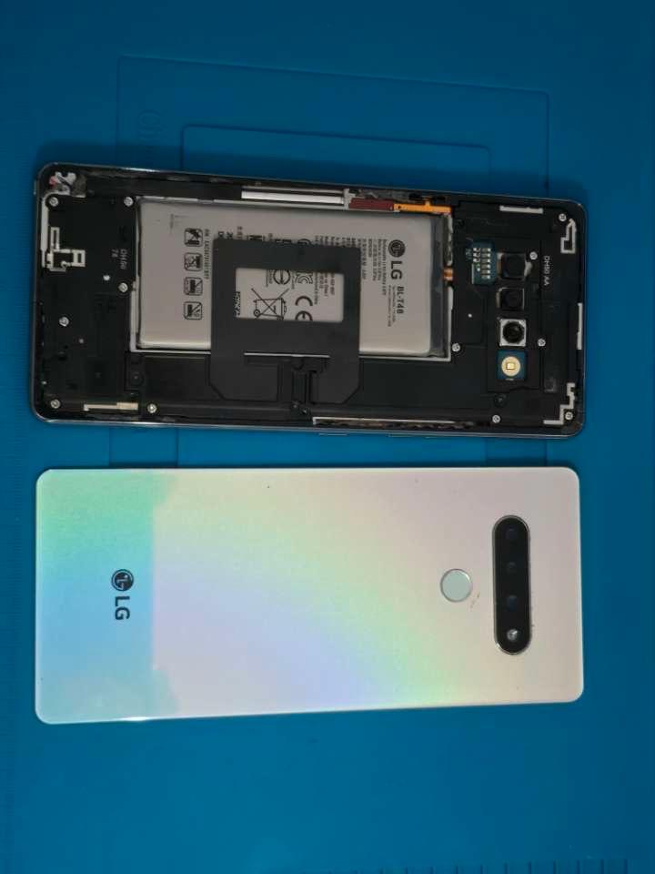 LG smartphone reassembly with back cover and battery visible