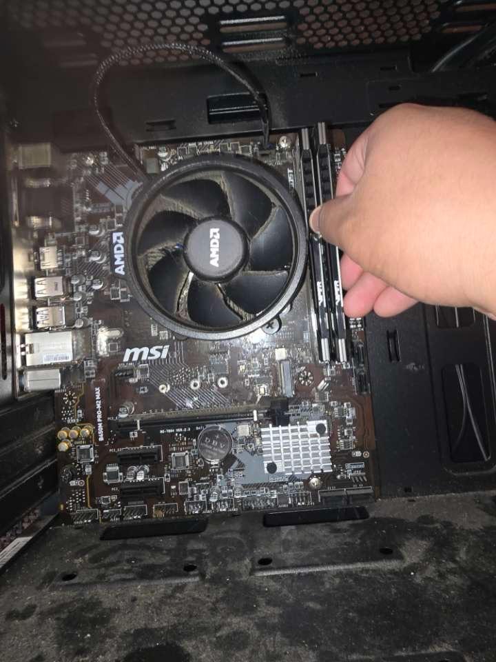 Desktop motherboard with RAM installation in progress